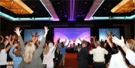 conference room with people raising hands