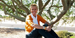 judy kay sitting in front of tree